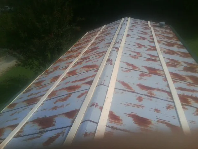 Rusted metal roof panels with new wood purlins before replacement — Storm Damage Roof Repair in Jourdanton by Roofing Brothers